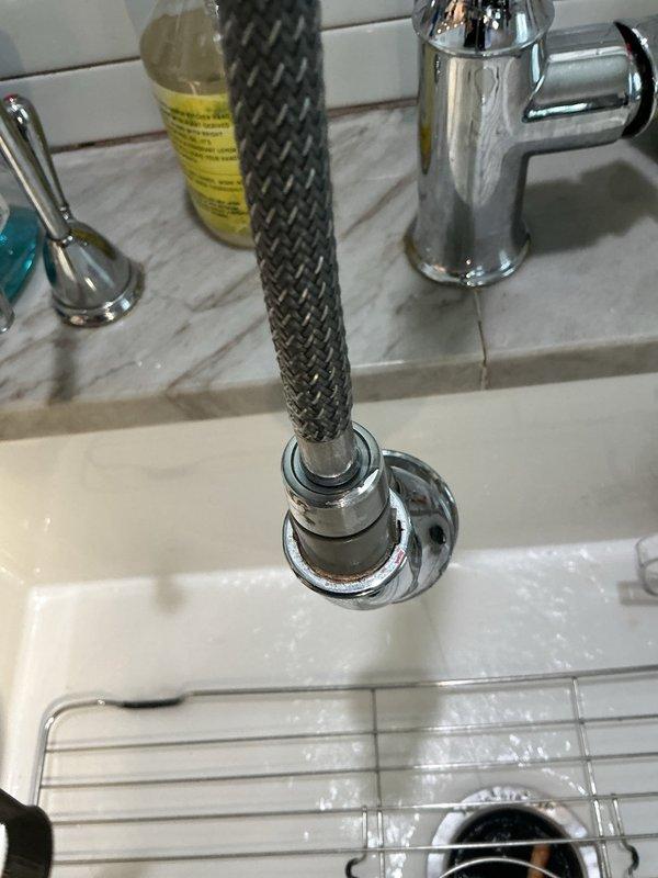 Responded to service call for reported leak under kitchen sink. Upon arrival, performed visual inspection of undermount sink basin, faucet assembly, and supply connections. Examined braided metal spray hose attachment and mounting hardware for signs of moisture or deterioration. Inspected cabinet interior beneath sink for active water intrusion, damaged supply lines, or compromised drain connections. Verified proper operation of faucet and sprayer mechanism to identify source of reported leak.