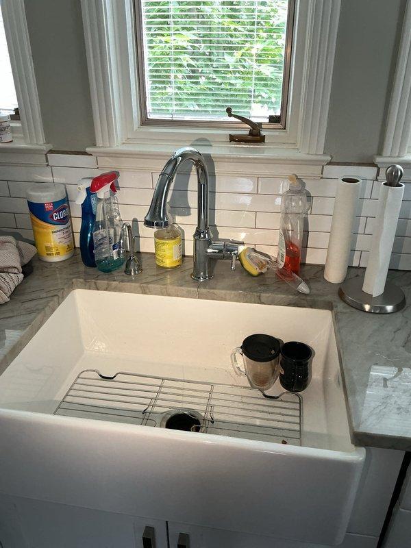 Responded to service call for reported leak under kitchen sink. Upon arrival, performed visual inspection of undermount sink basin, faucet assembly, and supply connections. Examined braided metal spray hose attachment and mounting hardware for signs of moisture or deterioration. Inspected cabinet interior beneath sink for active water intrusion, damaged supply lines, or compromised drain connections. Verified proper operation of faucet and sprayer mechanism to identify source of reported leak.