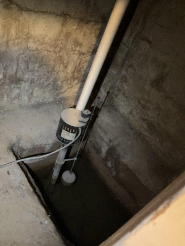 Performed comprehensive plumbing inspection of residential property to verify proper operation of all plumbing systems and components. Inspected Richmond-brand water heater installation including all supply and discharge connections, pressure relief valve, flexible stainless steel braided supply lines, and copper piping connections. Verified proper installation of all mounting hardware and fittings. Examined sump pump system including PVC discharge piping, pump mounting assembly, and sump pit operation. Assessed basement area for moisture conditions and proper drainage function. All plumbing systems found to be operating within normal parameters with no immediate repairs required at time of inspection.