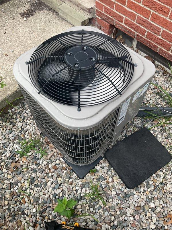Responded to service call for outdoor AC condenser unit producing intermittent loud buzzing sound while maintaining cooling operation. Upon arrival, performed visual and operational inspection of 5-year-old condensing unit located on gravel pad adjacent to building exterior. 

Diagnosed failed dual-run capacitor (Totaline P291-3554RS, 370/440VAC) as source of buzzing noise. Capacitor exhibited signs of electrical degradation causing intermittent arcing and audible buzzing during compressor cycling. Disconnected power at disconnect box and verified zero voltage before proceeding with component replacement.

Removed defective capacitor, disconnected all terminal connections including compressor, condenser fan motor, and common wire leads. Installed new dual-run capacitor with matching specifications, reconnected all wire terminals to proper HERM, FAN, and C terminals per wiring diagram. Verified all electrical connections were secure and properly seated.

Restored power to unit and perfo