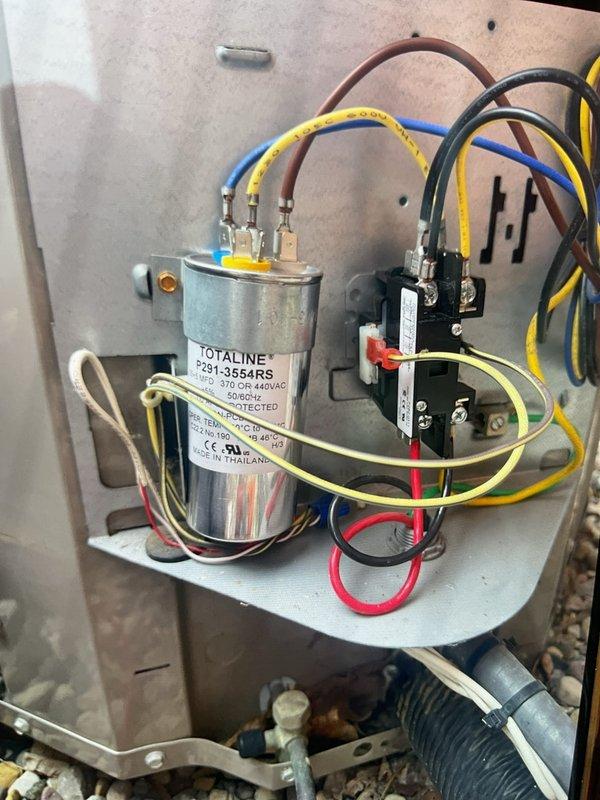 Responded to service call for outdoor AC condenser unit producing intermittent loud buzzing sound while maintaining cooling operation. Upon arrival, performed visual and operational inspection of 5-year-old condensing unit located on gravel pad adjacent to building exterior. 

Diagnosed failed dual-run capacitor (Totaline P291-3554RS, 370/440VAC) as source of buzzing noise. Capacitor exhibited signs of electrical degradation causing intermittent arcing and audible buzzing during compressor cycling. Disconnected power at disconnect box and verified zero voltage before proceeding with component replacement.

Removed defective capacitor, disconnected all terminal connections including compressor, condenser fan motor, and common wire leads. Installed new dual-run capacitor with matching specifications, reconnected all wire terminals to proper HERM, FAN, and C terminals per wiring diagram. Verified all electrical connections were secure and properly seated.

Restored power to unit and perfo