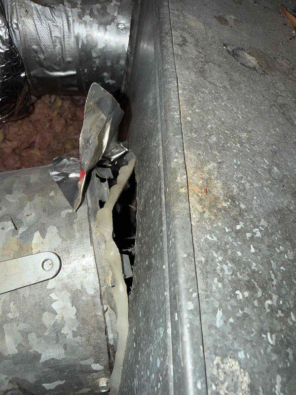 Responded to service call for 4-year-old AC system in attic blowing warm air only, with issue beginning shortly after recent maintenance inspection. Upon arrival, performed diagnostic evaluation of air handler unit and ductwork system. Inspection revealed deteriorated ductwork components with significant coating degradation and peeling on transition pieces and register boots. Assessed air handler cabinet condition, noting loose insulation material around equipment seams and edges. Checked electrical connections and service wiring. Provided complimentary filter replacement as part of pending Gold Plan service. System evaluated under parts warranty coverage.