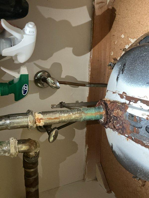 Completed on-site assessment of main floor bathroom plumbing requiring fixture and drain line replacement. Documented extensive deterioration of existing porcelain sink showing severe rust staining, mineral deposits, and discoloration concentrated around drain assembly. Inspected undersink plumbing revealing heavily corroded metal drain pipes with advanced rust damage throughout vertical and horizontal runs. Noted deteriorated pipe insulation and compromised connection points indicating long-term moisture exposure and aging infrastructure. Photographed all affected components including sink basin condition and corroded drain assembly to provide comprehensive documentation for replacement estimate. Recommended complete removal and replacement of sink fixture and associated drain piping due to extent of corrosion and potential for imminent failure.