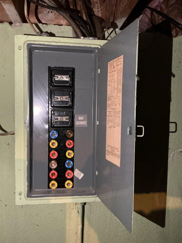 Completed estimate for replacement of 30-year-old furnace and air conditioning system. Furnace unit located in basement mechanical room with existing humidifier attachment, air conditioner positioned in backyard. Both units have reached end of expected service life and customer requested replacement pricing. Photographed existing equipment including furnace with mounted humidifier, electrical panel, and overall installation configuration for accurate system sizing and replacement planning.