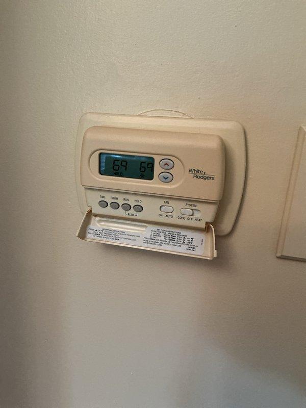 Completed Gold AC Inspection and maintenance on residential HVAC system with 12-year-old furnace located in basement. Upon inspection, discovered significant frost and ice accumulation on evaporator coil and ductwork in attic air handler, indicating restricted airflow or low refrigerant charge. Verified White-Rodgers programmable thermostat operation showing 69°F setpoint. Documented system conditions with photos showing extensive frost buildup on metal ductwork and air handler components, along with proper PVC condensate drain installation. System requires immediate attention to resolve freezing issue—likely causes include dirty evaporator coil, low refrigerant levels, inadequate airflow, or faulty expansion valve. Recommended follow-up service to diagnose root cause of icing condition, perform refrigerant charge verification, inspect blower motor operation, and clean evaporator coil as needed to restore proper system function and prevent compressor damage.