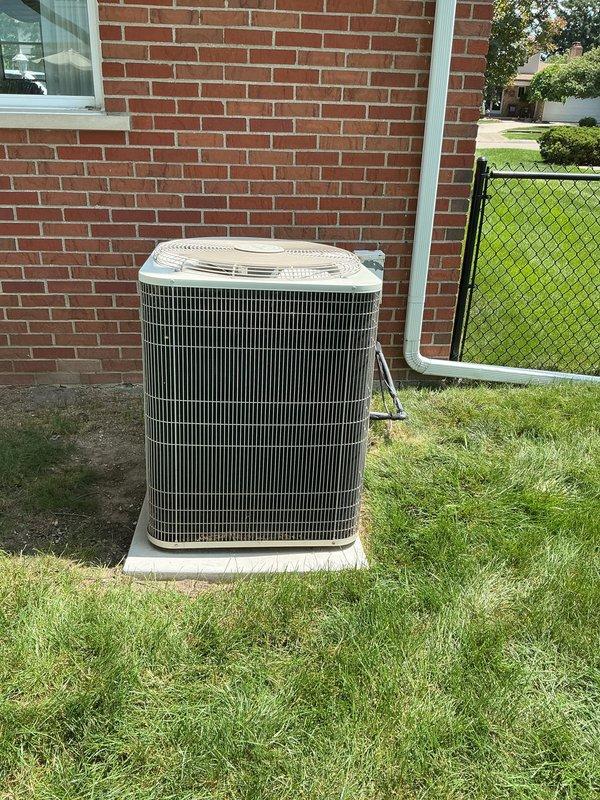 Evaluated 21-year-old R-410A air conditioning system experiencing coil freezing and complete loss of cooling capacity. Inspected outdoor condenser unit and indoor evaporator coils located in basement, assessed overall system condition including furnace components. Provided comprehensive replacement estimate due to age of equipment and extent of system deterioration beyond economical repair.