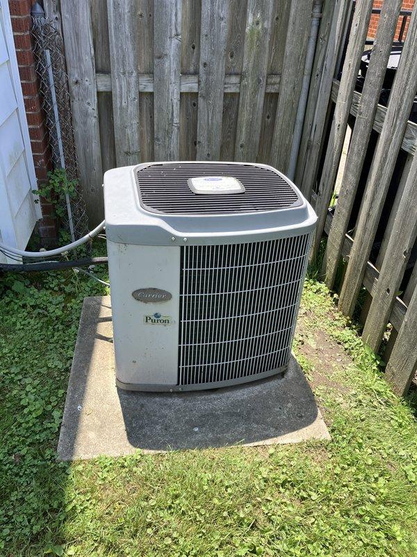 Conducted comprehensive estimate for AC system replacement due to short cycling issues on 10+ year old unit. Evaluated existing Carrier Puron system located in basement, assessed exterior condensing unit positioned on concrete pad in backyard, and documented current equipment condition including electrical connections, refrigerant lines, and mounting configuration. Provided homeowner with replacement options and specifications for new system installation to resolve operational concerns.
