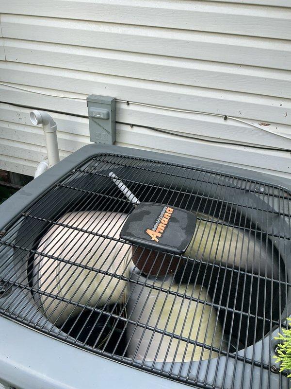 Completed comprehensive Gold AC inspection on 5-year-old residential air conditioning system. Performed thorough examination of outdoor condensing unit, confirming proper operation of all components. Inspected electrical disconnect, refrigerant line set, and condensate drainage system. Verified unit is functioning correctly with no immediate service needs identified. Checked cabinet condition, fan assembly, and protective grille. Documented equipment condition with photographs showing unit positioned on exterior pad with proper clearances maintained. All safety labels present and legible. System operating within normal parameters at time of inspection.