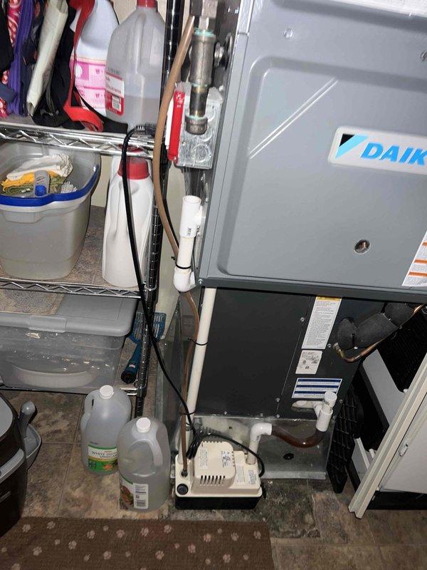 Completed comprehensive Gold AC inspection on 7-year-old Daikin air handling system located in utility room. Performed full system evaluation including visual inspection of unit components, refrigerant lines, condensate drainage system with pump, electrical connections, and airflow assessment. Verified proper operation of all equipment, checked PVC drainage lines for clogs or restrictions, inspected flexible ductwork connections, and confirmed condensate pump functionality. System found to be operating within normal parameters with no immediate service concerns identified at time of inspection.