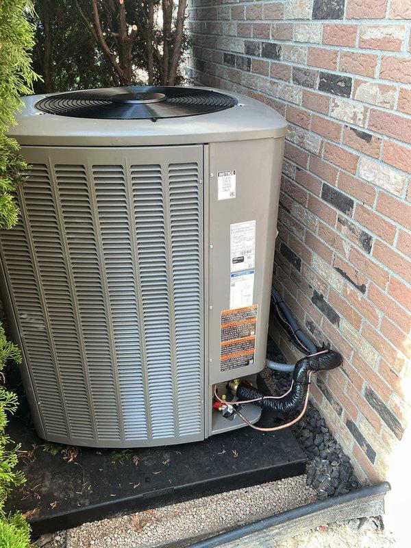 Completed full HVAC system installation including a 70,000 BTU furnace, 3-ton air conditioning unit, 50-gallon hot water tank, and humidifier. The AC condensing unit was positioned on a rubber pad in the right side yard against the brick exterior wall, with refrigerant lines properly insulated and routed through the wall. All electrical connections were completed, including meter reconnection. System was flushed and tested for proper operation. Mechanical permit was obtained prior to installation, and all equipment was commissioned and left in operational condition.