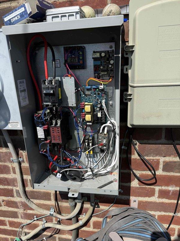 # Generator Power Distribution Repair

Responded to service call for a Briggs & Stratton 12kW standby generator experiencing partial power loss to residence. Upon arrival, performed comprehensive diagnostic evaluation of the unit and transfer switch system. Opened main electrical control panel to inspect internal components, connections, and control circuits.

Discovered voltage imbalance issue affecting power distribution to building circuits. Inspected circuit boards, transformers, relays, and terminal blocks within the control panel. Verified all wire connections at red and black terminal points, checking for loose connections or signs of overheating. Tested thick red power cables and traced circuits through the transfer switch assembly.

Examined voltage monitor settings documented on equipment housing, noting operational parameters set at 238V with ±10% tolerance thresholds. Evaluated circuit breaker positions and disconnect switch operation. Inspected all colored wire runs includ