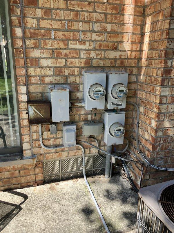 Responded to service call for inadequate cooling from 20+ year-old air conditioning system located in backyard patio area. Performed comprehensive evaluation of outdoor condenser unit positioned on concrete pad against building exterior. Assessed aging equipment condition, documented existing installation including electrical connections, meter configuration, and utility infrastructure. Based on system age and performance issues, provided detailed estimate for complete HVAC system replacement to restore proper cooling capacity and improve energy efficiency.