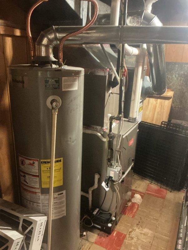 Responded to service call for AC system not cooling properly, with indoor temperature stuck at 77 degrees. Upon arrival, found system had previously experienced freezing issues with water pooling at furnace base. Performed diagnostic evaluation of 4-year-old outdoor condensing unit and indoor air handler. Verified thermostat operation and confirmed recent air filter replacement by homeowner. Documented system conditions with photos showing thermostat reading and indoor HVAC equipment setup. System had been allowed to thaw for two hours prior to arrival, with no active water accumulation present at time of inspection.
