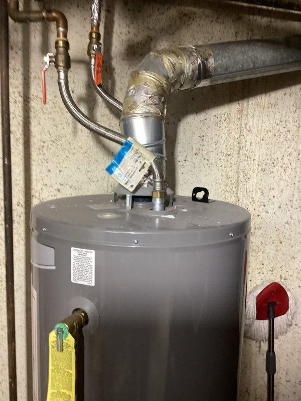 Conducted comprehensive full system estimate for residential HVAC replacement. Assessed existing furnace cabinet with galvanized metal exterior showing well-maintained condition, documented refrigerant line configuration and condensate piping arrangement. Evaluated water heater installation including copper supply lines, brass shut-off valves, and flexible connectors to provide complete system replacement recommendations and captured detailed photographic documentation for estimate preparation.