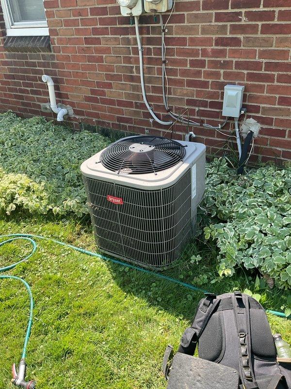 Completed comprehensive Gold AC Inspection on residential outdoor condensing unit and indoor evaporator coil system. Unit found operating within normal parameters with proper airflow through condenser fins and evaporator coil; diamond-pattern filter access panel inspected and coil condition documented. Confirmed electrical disconnect box functioning properly and all refrigerant lines secured to exterior wall mounting.