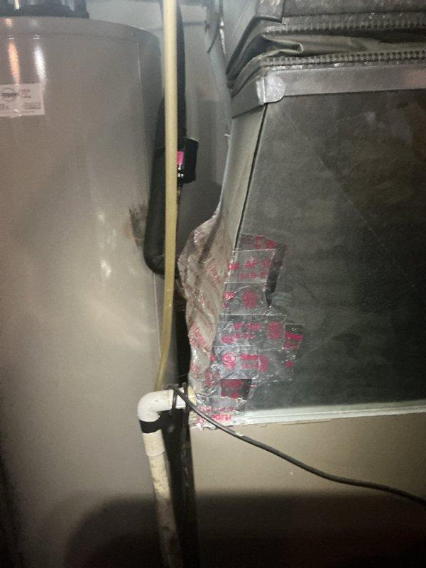 Responded to no cooling complaint on 10+ year old air conditioning system located in basement. Upon arrival, found thermostat not communicating with air handler unit. Inspected HVAC equipment including gray metal air handler and associated ductwork. Diagnosed communication failure between thermostat and system controls. Troubleshot electrical connections, control board, and wiring between thermostat and equipment. Verified power supply to unit and checked for loose connections at air handler. Restored proper communication between thermostat and system, confirmed cooling operation restored, and tested system functionality before departure.