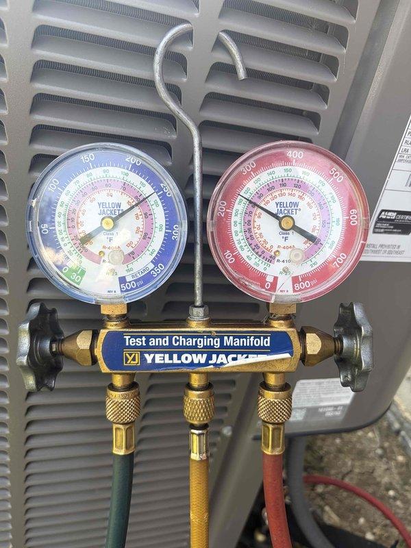 Performed leak search on HVAC system and located refrigerant leak. Connected manifold gauge set to measure system pressures and utilized micron gauge to verify system vacuum levels, achieving 950 microns reading which confirmed system integrity after repair. Successfully completed leak repair and prepared system for proper refrigerant recharge.