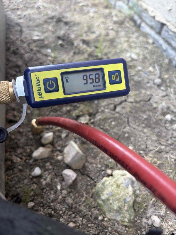 Performed leak search on HVAC system and located refrigerant leak. Connected manifold gauge set to measure system pressures and utilized micron gauge to verify system vacuum levels, achieving 950 microns reading which confirmed system integrity after repair. Successfully completed leak repair and prepared system for proper refrigerant recharge.
