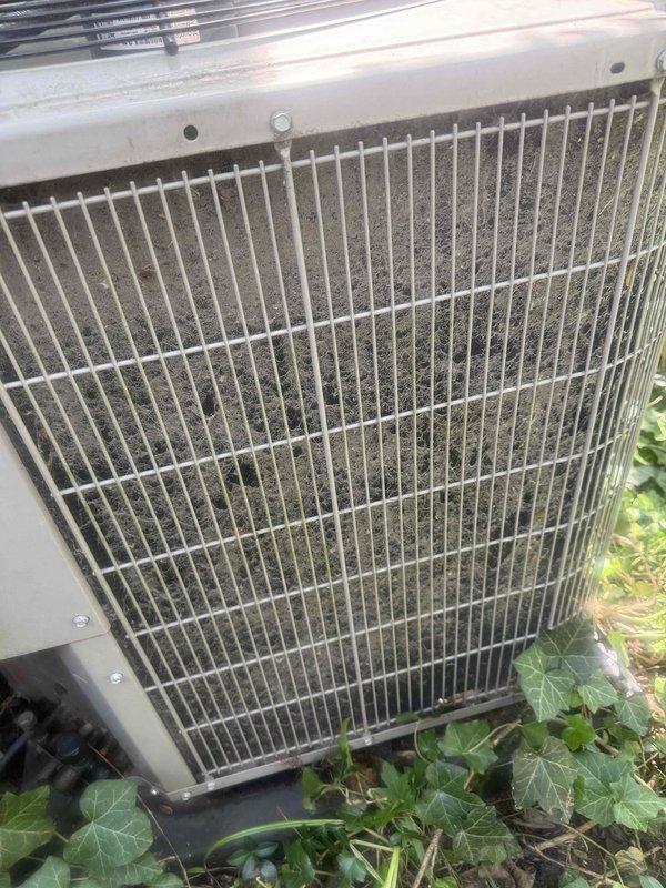 Responded to service call for 12-year-old AC system with non-operational condenser fan motor and unlevel outdoor unit. Upon arrival, found condenser unit heavily soiled with debris accumulation on coil fins and encroaching vegetation around base. Diagnosed failed condenser fan motor preventing proper heat rejection. Cleaned condenser coils, removed debris buildup, and cleared vegetation from unit perimeter. Replaced defective condenser fan motor and capacitor. Leveled outdoor condenser unit on pad to manufacturer specifications to ensure proper drainage and operation. Verified system cooling capacity restored and all components operating within normal parameters. System returned to full operational status.