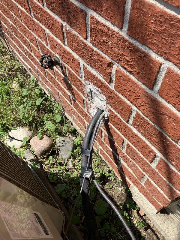 Conducted on-site evaluation of existing packaged air conditioning unit located on exterior concrete pad against brick foundation. Assessed current cooling system serving small residential space under 1500 square feet. Documented equipment condition, refrigerant line routing, electrical disconnect configuration, and unit placement for replacement estimate preparation.