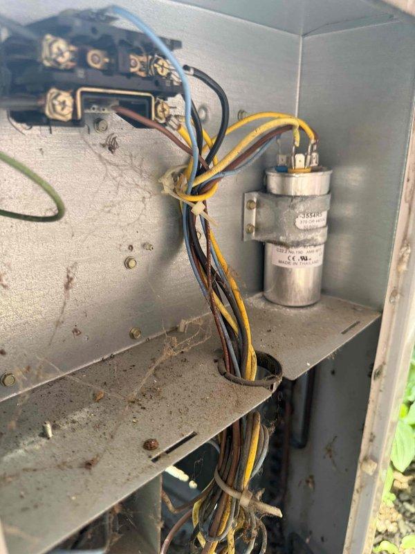 Responded to no cooling complaint on 15-year-old outdoor AC unit. Upon inspection, diagnosed failed dual run capacitor (35+5 MFD) preventing compressor and condenser fan operation. Removed defective capacitor from control panel and installed new Totaline 35+5 MFD 370/440VAC replacement capacitor. Verified all electrical connections secure, tested system operation, and confirmed proper cooling restored. Unit returned to normal operation.