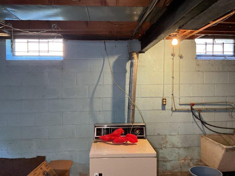 Installed shut-off valves on gas lines serving the dryer and furnace, which were previously hard-piped without individual isolation capability. Created wall access point through tiled surface to reach gas line connections, installed code-compliant ball valves on both appliance supply lines, and restored wall access opening. Work enables safe appliance disconnection for future service or replacement without shutting down entire gas system.