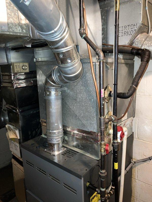 Responded to service call for air conditioning system not cooling with non-functional compressor unit located in backyard. Performed comprehensive system evaluation including inspection of outdoor condensing unit, indoor furnace with evaporator coil, refrigerant line set, thermostat controls, and ductwork connections. Documented existing equipment condition through detailed photography of thermostat interface, furnace cabinet assembly, copper refrigerant piping with service valves, and associated HVAC components. Provided estimate for complete system replacement due to compressor failure and age of existing equipment.