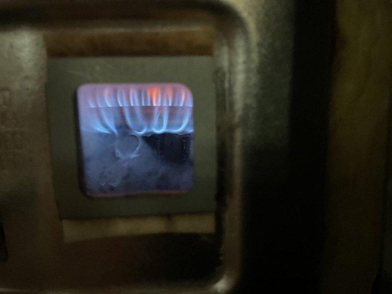 Responded to no hot water complaint at residential property. Upon inspection, found gas-fired water heater in basement with operational burner assembly showing proper flame characteristics and combustion. Verified gas supply line connection, checked water supply piping, and confirmed all safety controls and venting system were functioning correctly. Unit restored to proper operation with adequate hot water production.