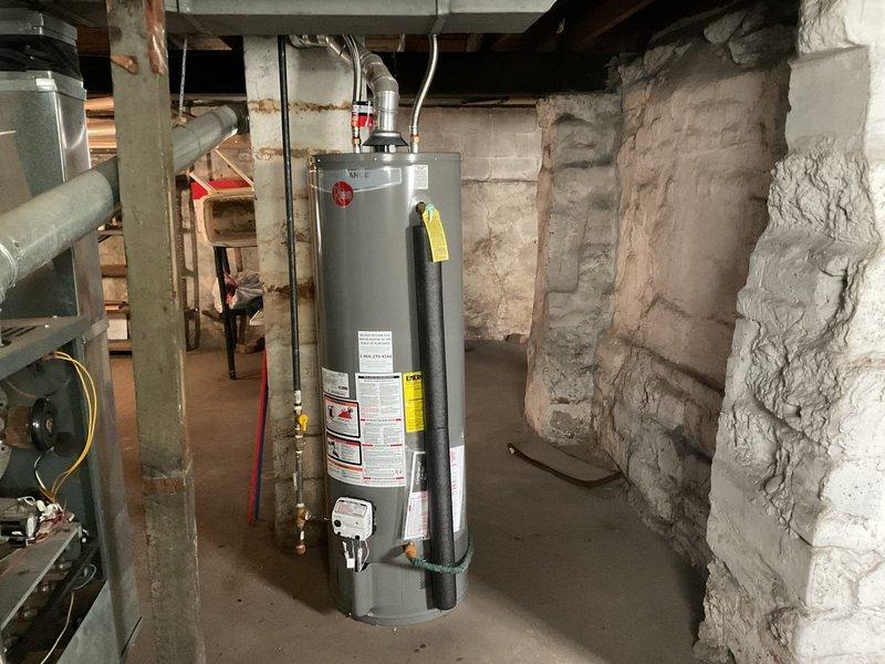 Responded to no hot water complaint at residential property. Upon inspection, found gas-fired water heater in basement with operational burner assembly showing proper flame characteristics and combustion. Verified gas supply line connection, checked water supply piping, and confirmed all safety controls and venting system were functioning correctly. Unit restored to proper operation with adequate hot water production.