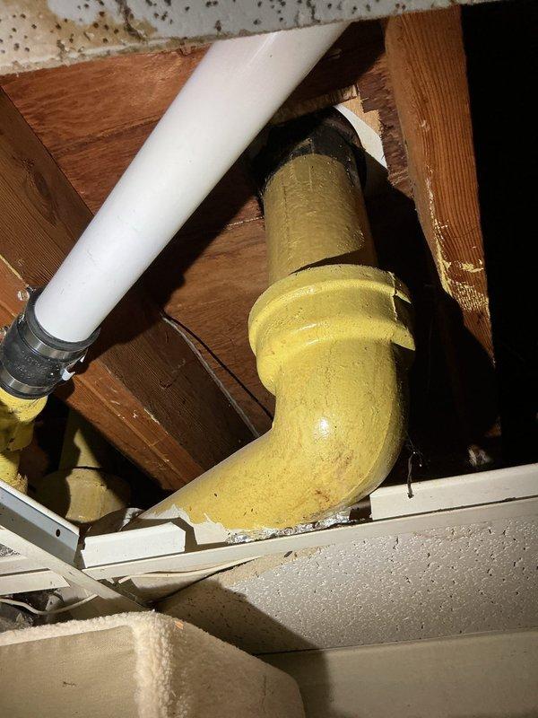 Responded to slow draining main floor shower in 20+ year old home with issue isolated to single fixture. Accessed attic space above affected shower to inspect drainage system and identify obstruction point. Located and cleared blockage in drain line, verified proper flow restoration, and confirmed all connections secure. Shower now draining at normal rate with no additional fixtures affected.