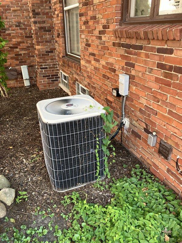 Responded to no-cooling call for residential property with 23-year-old Carrier air conditioning system that had completely failed. Upon inspection, documented existing equipment including outdoor condensing unit with significant vegetation overgrowth and aging indoor furnace with visible wear. Due to advanced age of system and complete failure, provided comprehensive full system replacement estimate covering both outdoor condensing unit and indoor air handler components, explaining benefits of modern high-efficiency equipment versus repair costs on dated system.
