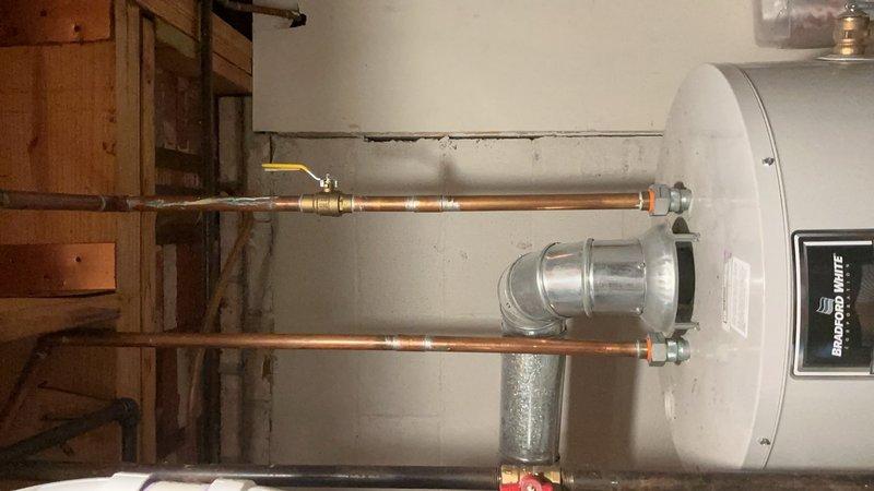 Completed comprehensive Gold AC inspection on 4-year-old residential cooling system with air handler located in basement and condenser unit positioned on ground-level pad adjacent to rear deck. Performed full system evaluation including refrigerant charge verification, electrical connections inspection, condensate drain assessment, air filter examination, and thermostat functionality testing. Inspected outdoor condenser unit mounted on black composite pad, verified proper airflow through coil fins, and noted presence of organic debris and leaf accumulation around unit perimeter requiring customer attention for optimal system performance and efficiency.