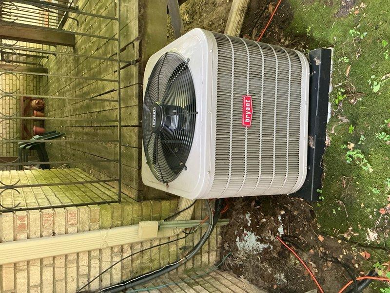 Completed comprehensive Gold AC inspection on 4-year-old residential cooling system with air handler located in basement and condenser unit positioned on ground-level pad adjacent to rear deck. Performed full system evaluation including refrigerant charge verification, electrical connections inspection, condensate drain assessment, air filter examination, and thermostat functionality testing. Inspected outdoor condenser unit mounted on black composite pad, verified proper airflow through coil fins, and noted presence of organic debris and leaf accumulation around unit perimeter requiring customer attention for optimal system performance and efficiency.