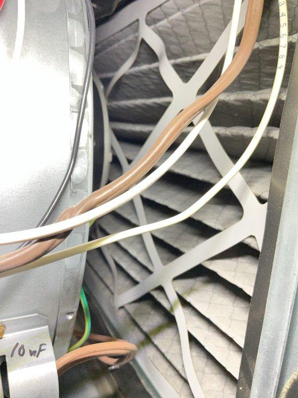Completed comprehensive Gold AC inspection on 10-year-old basement air handler system. Inspected blower assembly, verified proper operation of fan wheel and motor, checked electrical connections including ground wire integrity, and documented capacitor rating (10µF). Observed significant frost and condensation accumulation on refrigerant line insulation, indicating possible low refrigerant charge, restricted airflow, or metering device issue requiring further diagnostic evaluation and potential service.