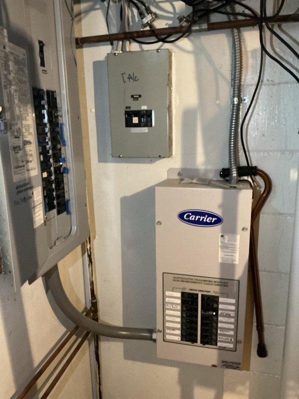 Completed generator replacement at residential property, removing existing Carrier 15kW unit from back patio location. Installed new standby generator system with associated electrical components, including transfer switch, circuit breaker panels, and meter connections mounted on exterior brick wall. Established proper conduit runs, wiring connections, and fuel lines to restore automatic backup power capability to home.