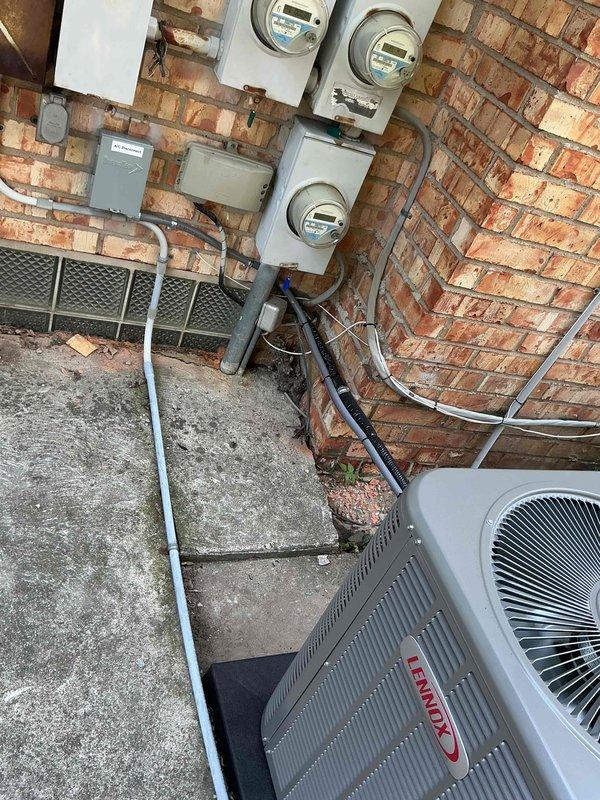 Completed installation of 2-ton air conditioning system with matching evaporator coil in rear yard location. Unit was positioned on pad against exterior brick wall near existing electrical meters, with all refrigerant lines, electrical connections, and condensate drainage properly installed and reconnected. Mechanical permit was requested for the installation, and system was tested for proper operation upon completion.