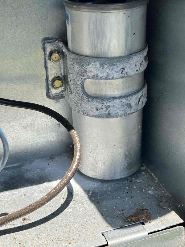 Completed comprehensive Gold AC Inspection on 25+ year old HVAC system with basement-located air handler. Performed full system evaluation including visual inspection of outdoor unit components, refrigerant lines, and electrical connections. Measured and recorded system voltage readings using digital multimeter, confirming proper electrical supply to equipment. Inspected copper refrigerant lines showing age-appropriate weathering and patina, foam insulation sleeves, and mounting hardware for secure installation. All components assessed for operational safety and efficiency on single-unit residential system.