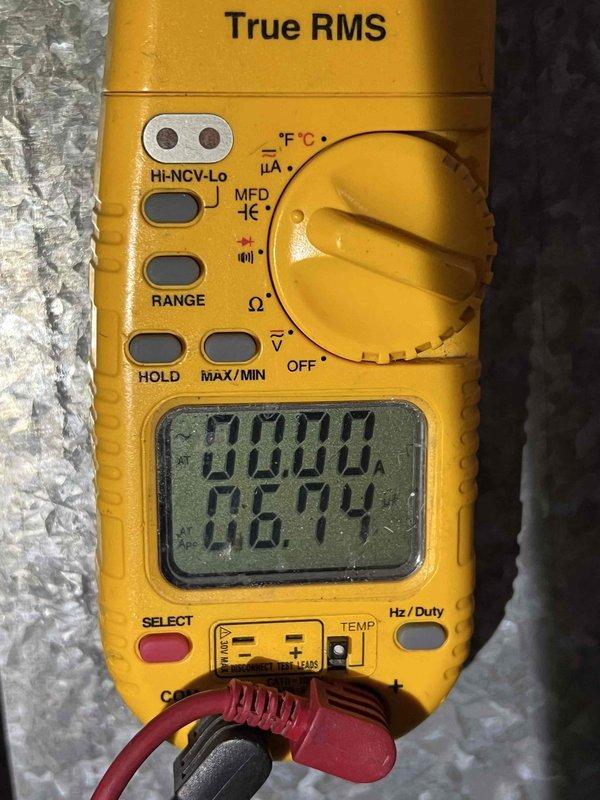 Completed comprehensive Gold AC Inspection on 25+ year old HVAC system with basement-located air handler. Performed full system evaluation including visual inspection of outdoor unit components, refrigerant lines, and electrical connections. Measured and recorded system voltage readings using digital multimeter, confirming proper electrical supply to equipment. Inspected copper refrigerant lines showing age-appropriate weathering and patina, foam insulation sleeves, and mounting hardware for secure installation. All components assessed for operational safety and efficiency on single-unit residential system.