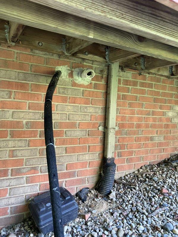 Conducted comprehensive gold-level air conditioning inspection on a 10+ year old Lennox R22 system with outdoor condenser unit located against building foundation beneath deck structure and air handler positioned in basement. Evaluated operational status of functioning equipment, documented existing system configuration including electrical components and drainage setup, and provided replacement estimate recommendations for aging R22 refrigerant system approaching end of service life.