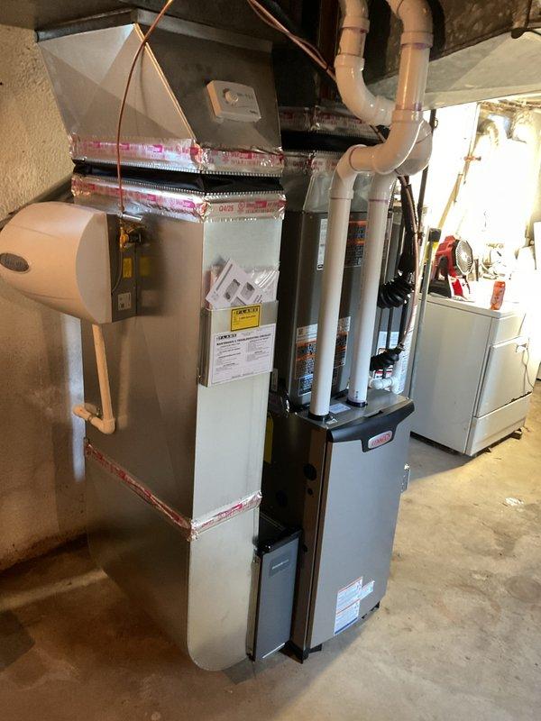 Completed full HVAC system replacement in basement utility area, installing new 70,000 BTU gas furnace with integrated humidifier and 2.5-ton air conditioning unit with rear discharge configuration. Installed new programmable thermostat, ran copper refrigerant lines, and connected all ductwork with proper plenum integration. Reconnected electrical service, installed condensate pump with 500-micron evacuation, and ensured all connections met code requirements for mechanical and electrical permits. System tested and verified operational with AHRI certification number 215663885, qualifying for applicable utility rebate programs.