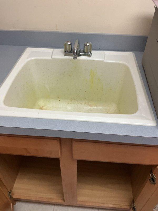 Installed and connected new laundry tub and dual-handle chrome faucet assembly. Completed all plumbing connections including P-trap installation with white PVC drain assembly, verified proper drainage function, and ensured all fixtures were securely mounted and leak-free.
