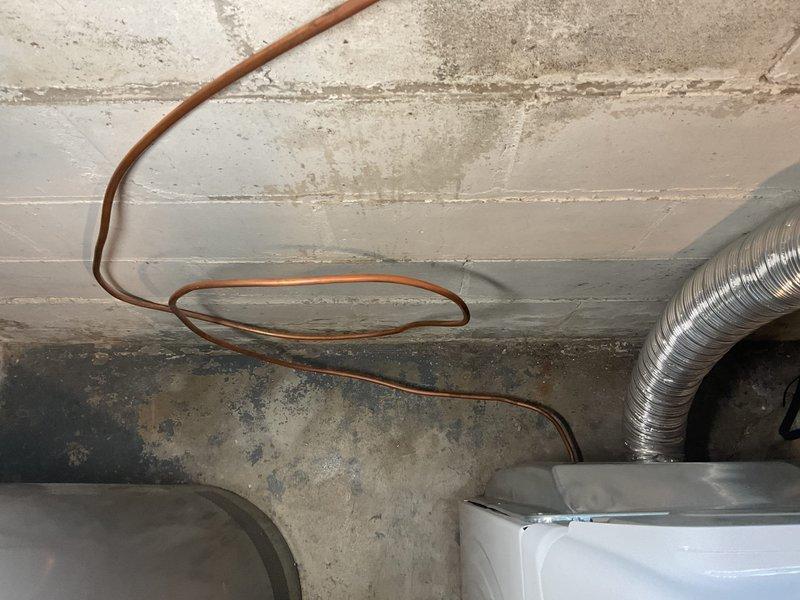 Performed plumbing estimate for gas line assessment in basement of 60+ year old home requiring correction or update for new dryer installation. Inspected existing gas piping configuration, which was suspected to be improperly sized or routed for dryer connection. Evaluated copper gas lines, shutoff valves, and existing mechanical connections in utility area. Documented current piping layout and identified necessary modifications to bring gas supply up to code for safe dryer operation. Provided recommendations for proper gas line sizing, routing, and installation to meet current building codes and manufacturer specifications.