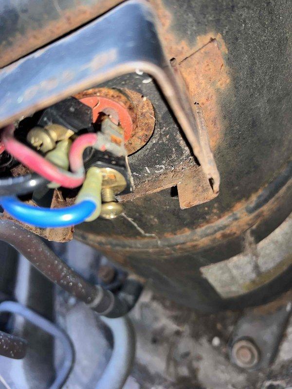 Responded to no-cooling complaint on 25-year-old residential AC system. Upon inspection, found compressor unit completely inoperative with extensive corrosion throughout electrical connections and refrigerant line components. Outdoor unit exhibited severe rust deterioration on compressor housing, electrical terminals, and service valve assemblies, indicating prolonged moisture exposure and end-of-service-life condition. Electrical connections showed compromised integrity with corroded terminals and mounting brackets. Refrigerant line coupling displayed advanced oxidation with structural degradation. Documented equipment condition with photographs showing rust damage to compressor electrical components, service valves, and connection points. Given the age of the system and extent of corrosion damage, recommended full system replacement rather than repair due to safety concerns and likelihood of additional component failures. Customer was unavailable after 1 PM as noted, so findings and 