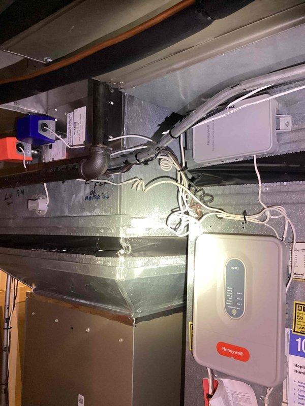 Performed comprehensive evaluation of 20-year-old HVAC system located in basement following reports of furnace failure. Assessed existing air handler unit, ductwork configuration, and associated mechanical components including Honeywell control systems. Documented current equipment condition through photographic records showing existing thermostat set at 80 degrees and overall system layout. Provided detailed replacement estimate for complete HVAC system replacement due to age and equipment failure.
