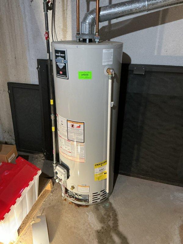 Responded to service call for gas-fired water heater not producing hot water. Upon arrival, performed diagnostic inspection of 6-year-old residential tank-style water heater still under manufacturer's 10-year warranty. Visual examination revealed extensive rust corrosion and deterioration around the burner assembly and base of the unit, indicating prolonged moisture exposure and potential tank failure. Rust staining was present on the concrete floor surrounding the water heater base, suggesting active or recent leaking. Inspected all plumbing connections, temperature and pressure relief valve, gas supply line, and exhaust venting system. Documented the severe corrosion damage with photographs showing compromised structural integrity at the tank base and burner compartment. Based on the extent of rust damage and loss of hot water functionality, determined that the unit requires warranty replacement rather than repair. Advised homeowner that the corrosion pattern indicates the tank has l