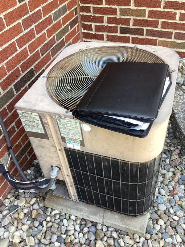 Responded to service call for 30-year-old central air conditioning system with inadequate cooling performance. Conducted comprehensive system evaluation of outdoor condenser unit located at rear of property, documenting equipment condition and specifications. Assessed aging equipment and provided replacement estimate options based on system age, performance deficiencies, and current operational status.