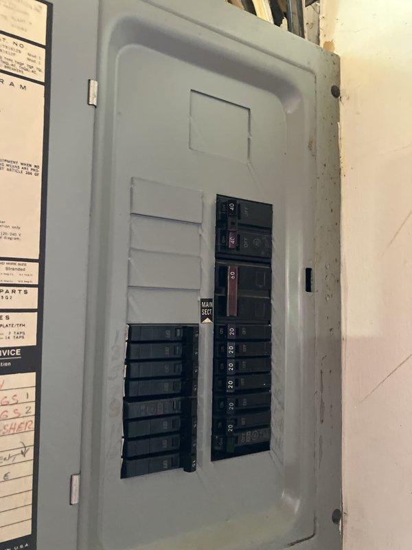 Conducted on-site assessment for complete HVAC system replacement including 22-year-old furnace and air conditioning unit, both located in basement. Evaluated existing outdoor condenser unit positioned on concrete pad against exterior wall, inspected electrical service panel and existing wiring configuration to determine compatibility requirements for new equipment installation.