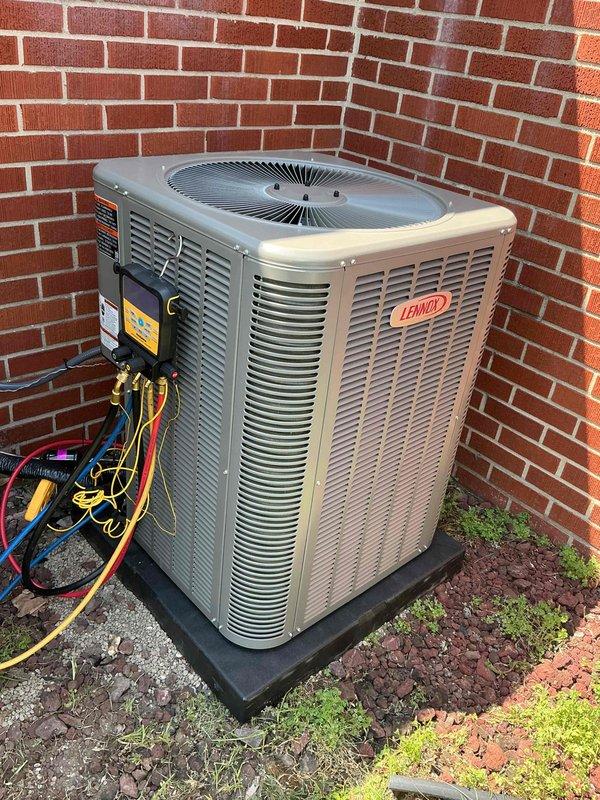 Completed installation of 3-ton Lennox air conditioning system with matching evaporator coil. Indoor coil was installed on existing furnace in basement utility area with proper refrigerant line connections, condensate drainage via PVC piping, and metal ductwork integration to existing plenum. Outdoor condensing unit was positioned on equipment pad in rear of property against brick wall structure with proper clearances maintained. Refrigerant lines were run and connected between indoor and outdoor components, system was evacuated, charged to manufacturer specifications, and tested for proper operation. All electrical connections were completed and reconnected per code requirements. System startup confirmed proper airflow, temperature split, and operational parameters within acceptable ranges.