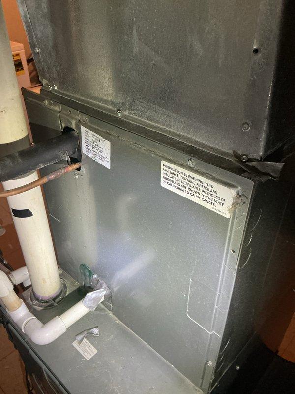 Completed comprehensive Gold AC inspection and tune-up on 30-year-old air conditioning system as part of annual maintenance program. System found operating properly with all components functioning within normal parameters. Inspected air handler unit, condensate pump with drain pan assembly, and associated drainage piping. Verified electrical connections at condensate pump and wall outlet, checked copper refrigerant lines and PVC condensate drain lines for proper installation and operation. Documented equipment condition through photographic records showing utility area installation, air handler with metal ductwork, and condensate management system. All safety labels and warning decals confirmed present and legible on equipment. System cleared for continued operation with next scheduled maintenance due in 2026.
