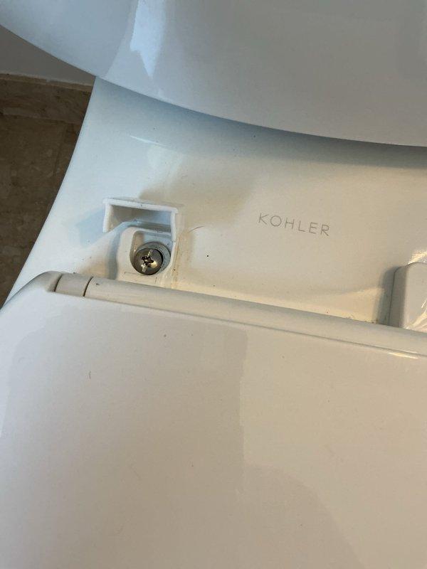 Responded to service call for loose toilet seat on Kohler toilet with broken plastic mounting hardware. Removed damaged mounting bolt assembly, installed new toilet seat mounting hardware with stainless steel bolts and stabilizing hardware, and secured seat firmly to bowl. Verified proper alignment and stability of seat and lid upon completion.